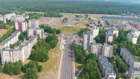 Apartment-building-and-street-traffic-in-suburbs-of-Kaunas-city,-aerial-view