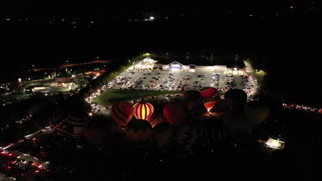 Hot-Air-Balloons-display-light-up-during-the-night-at-a-Amusement-Park,-FunFair-in-West-Virginia,-USA