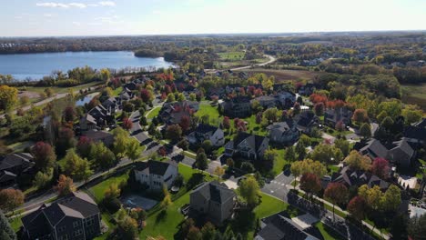 Drone-flies-through-neighborhood-with-colorful-autumn-leaves