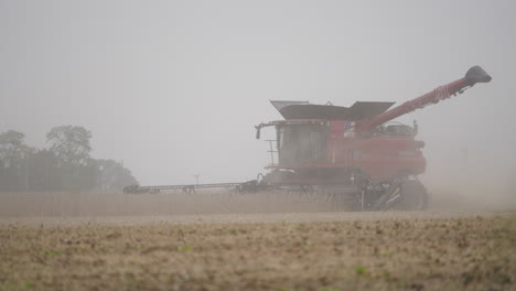Combine-Harvester-with-Spinning-Header-Harvesting-Crops-on-Dusty-Overcast-Day
