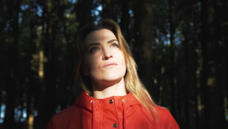 Woman-standing-in-beautiful-forest-sunlight-Orbit-Shot