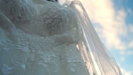 Close-up-view-of-the-bride's-wedding-dress-on-a-sunny-morning