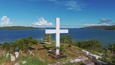 Aerial-Shot-of-Catholic-Cemetery-Overlooking-Bay-in-Surigao-Del-Norte,-Philippines