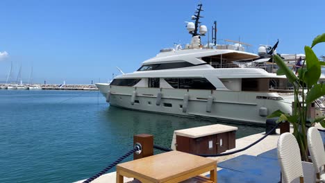 Big-luxury-yacht-parked-in-Puerto-Banus-port-by-the-pier-during-summer-in-Marbella-Spain,-living-the-good-life,-beautiful-Mediterranian-sea,-jetset-elite-lifestyle,-4K-shot