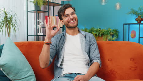 Happy-cheerful-Indian-man-looking-approvingly-at-camera-showing-ok-gesture,-positive-like-sign