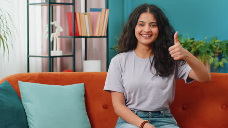 Happy-Indian-young-woman-looking-approvingly-at-camera-show-thumbs-up-like-positive-sign-good-news