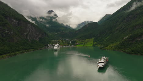 Cruise-ships-docked-in-scenic-fjord-in-Geiranger,-Norway