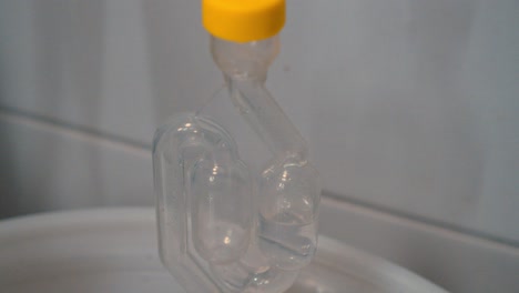 Close-up-of-a-safety-tube-with-boiling-clear-liquid-in-a-laboratory-experiment