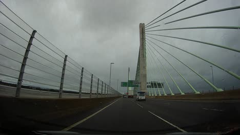 POV-dash-cam-driving-across-Mersey-gateway-bridge-in-cloudy-overcast-morning-traffic