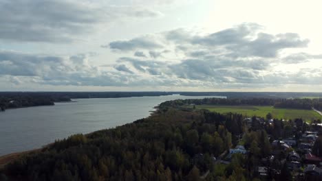 Panoramic-dolly-out-drone-shot-of-lake-Tuusula-in-southern-Finland,-quiet,-sunny-and-lonely-place