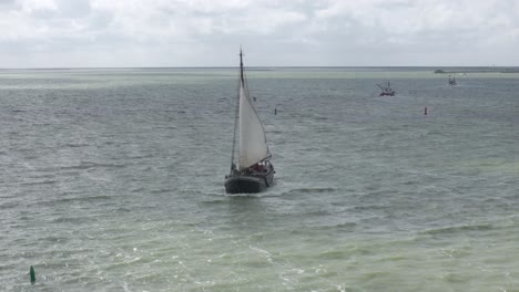 Old-dutch-sail-vessel-sailing-on-Ijsselmeer-near-Makkum,-aerial
