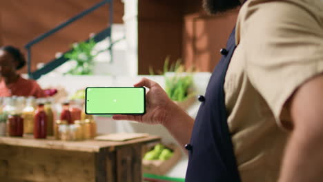 Local-vendor-holds-greenscreen-phone
