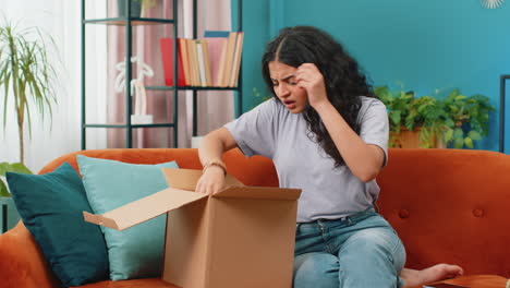Angry-dissatisfied-shopper-Indian-woman-unpacking-parcel-feeling-upset,-confused,-wrong-delivery