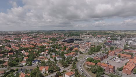 Old-medieval-city-Ystad-in-Sweden,-aerial-forward-on-cloudy-summer-day