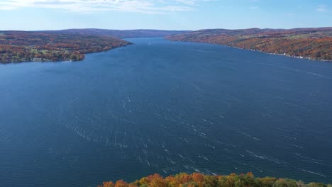Aerial-view-of-Keuka-Lake-in-the-Finger-Lakes,-NY-from-the-point-of-the-bluff-during-fall,-showing-colorful-foliage