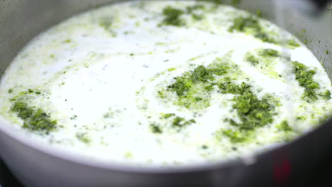Coconut-milk-poured-into-Thai-green-curry-paste