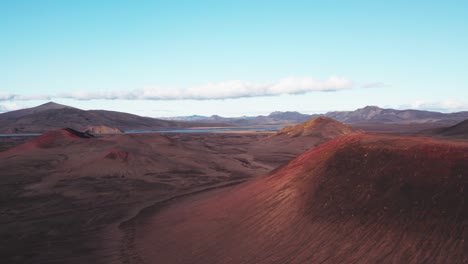 Aerial:-flyover-reveal-view-of-dormant-and-vibrant-red-and-black-volcano-on-a-clear-day-in-Iceland-highlands