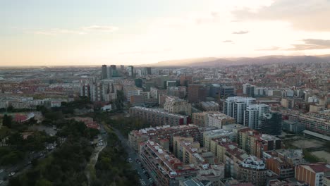 Forward-Drone-Shot-Above-Beautiful-Barcelona,-Spain-at-Sunset