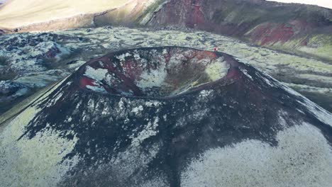 Aerial-reverse-view-of-red-and-green-colored-Icelandic-Volcano-that-is-a-captivating-and-geologically-significant-features-of-the-Highlands
