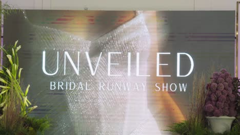 Hand-held-shot-of-the-LED-board-of-the-Unveiled-bridal-runway-show-in-Indianapolis