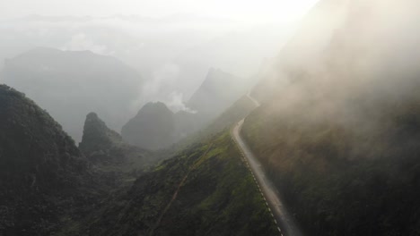Low-clouds-on-Ma-pi-leng-pass-Vietnam-with-motorbike-driving,-aerial