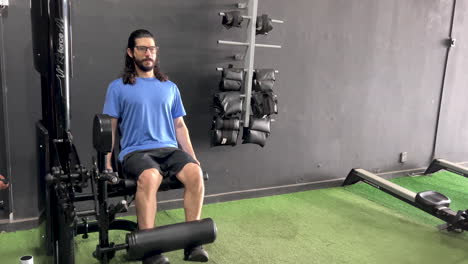 Latin-man-with-beard-and-long-hair-in-extension-chair-equipment