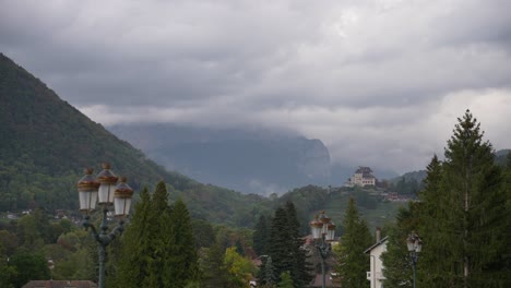 Mont-Semnoz-behind-clouds-seen-from-the-town-of-Annecy-in-the-French-Alps,-Stable-wide-shot