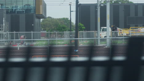 Filming-out-of-a-train-window-during-the-early-dawn-passing-railway-lines-and-a-train-yard-in-Sydney-Australia