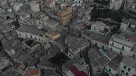 Top-down-view-of-old-town-of-Modica-at-Sicily-during-sunrise,-aerial