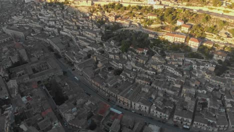 Wide-view-of-Modica-town-at-sicily-during-sunrise,-aerial