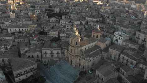 Orbit-shot-of-Cathedral-of-Saint-George-in-historic-town-of-Modica-in-Sicily,-aerial