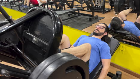 Latin-man-with-long-hair-and-beard-performing-leg-press-45-exercise