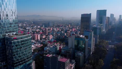 Drone-shot-Mexico-city-reforma-avenue-early-morning-landscape-skyline-urban-neighborhood