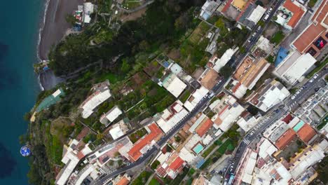 Top-down-aerial-view-at-colourful-houses-on-hills-in-Positano-town-in-Italy