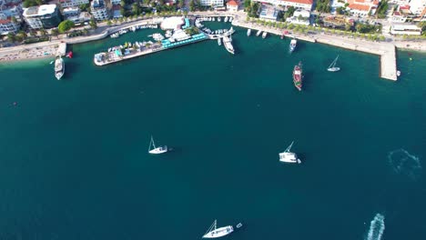 Sailing-Serenity-in-Coastal-Saranda:-Yachts-Grace-the-Calm-Bay,-Surrounded-by-Boats-and-Promenade,-Creating-the-Perfect-City-Holiday