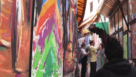 Wander-through-the-narrow-rainbow-street-of-Fes,-where-art-creates-an-open-gallery-of-creativity