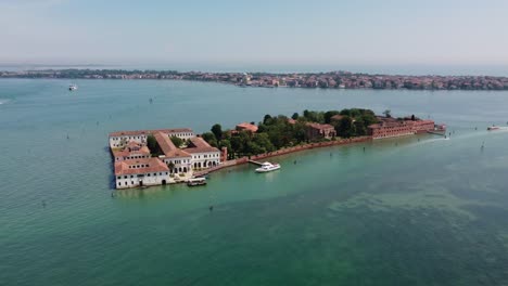 San-servolo-island-seen-from-drone,-showcasing-the-historic-architecture-during-daylight,-spring