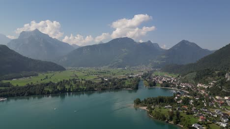 Aerial-drone-view-of-Walensee-lake,-Switzerland-with-boats