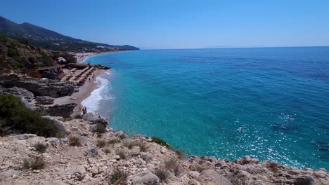 Summer-Escape:-Amazing-Beach-Encircled-by-Cliffs-on-the-Blissful-Ionian-Coast-of-Albania,-Perfect-for-a-Hot-Summer-Vacation