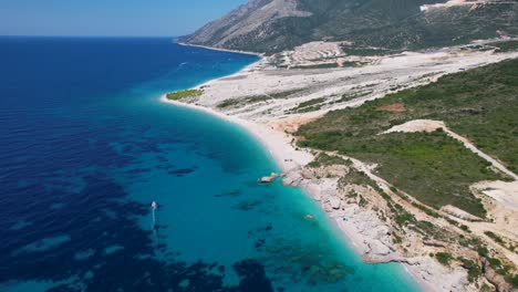 Ionian-Bliss:-Azure-Blue-Waters-of-the-Ionian-Sea-Caressing-the-Green-Coast-Resort-in-Albania,-the-Perfect-Destination-for-a-Holiday-Escape
