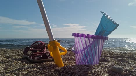 Toys-On-The-Beach-With-Bucket,-Spade,-And-Shovel-On-Sand