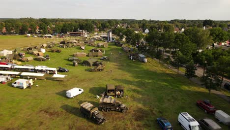Outdoors-military-exhibition-with-American-world-war-two-vehicles,-drone