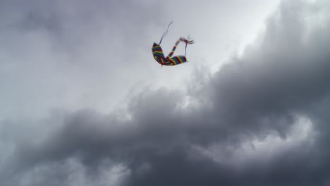 A-flying-kite-with-a-long-tail-flying-against-the-ominous-clouds-in-the-sky