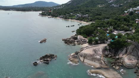 360-degrees-aerial-shot-of-rocky-beaches-and-green-hills-in-Koh-Samui-Thailand