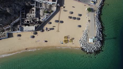 Aerial-view-of-the-beach-life-below-at-Cabo-San-Lucas-Marina-Pier