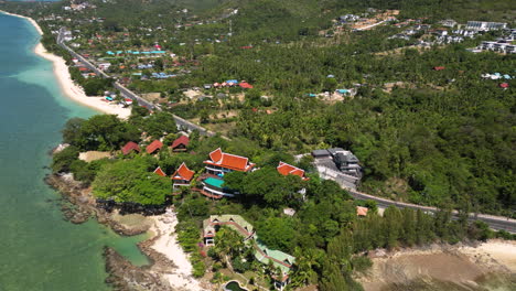 Waterfront-hotels-at-tropical-Bang-Por-beach-in-Koh-Samui,-Thailand,-aerial-view