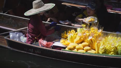 Sale-of-foodstuff-is-made-from-a-boat-to-tourists-at-a-floating-market