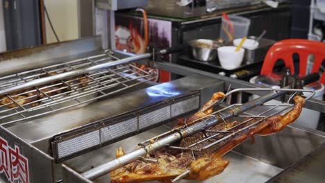 A-pig-and-other-foods-rotate-on-a-rotisserie-spit-in-a-restaurant