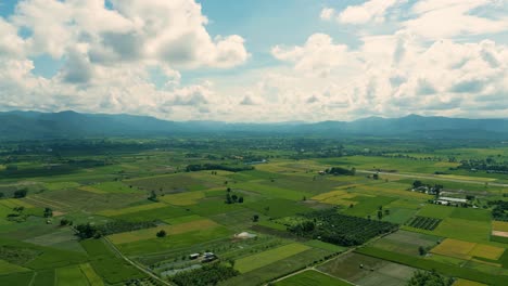 4K-Cinematic-nature-aerial-drone-footage-of-the-beautiful-mountains-and-fields-of-Mae-Taeng-next-to-Chiang-Mai,-Thailand-on-a-sunny-day