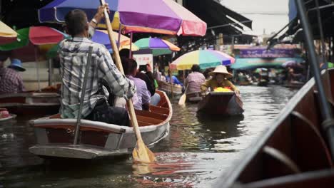 Busy-canal-is-plied-by-paddle-boats-as-tourists-are-ferried-between-shops
